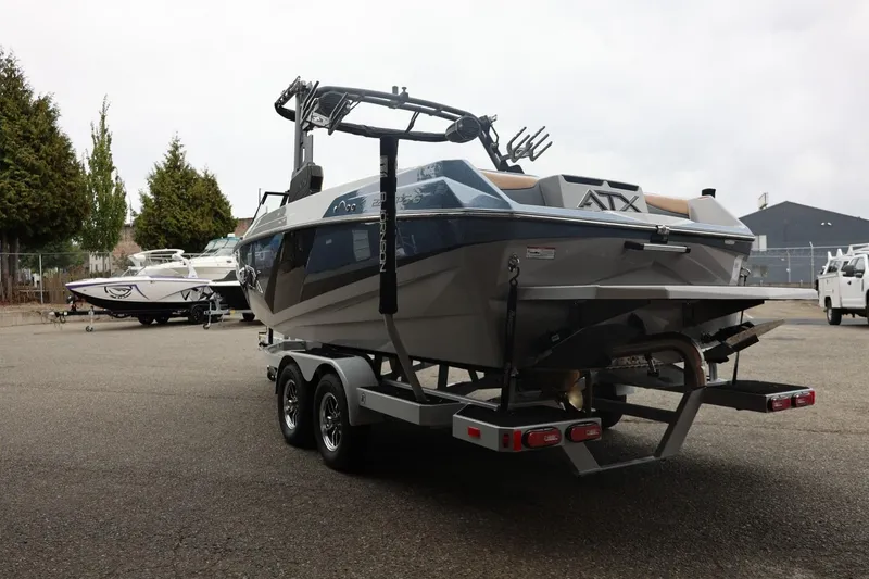 Slide: The Image of 2026 ATX Surf Boats 22 Type-S on trailer in parking lot, rear view. - 16
