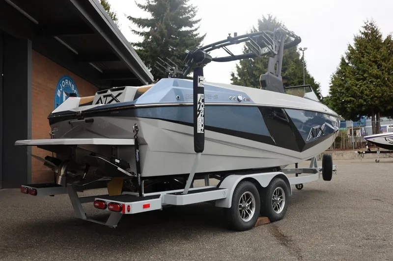 Slide: The Image of 2026 ATX Surf Boats 22 Type-S on trailer, parked outdoors near building. - 23