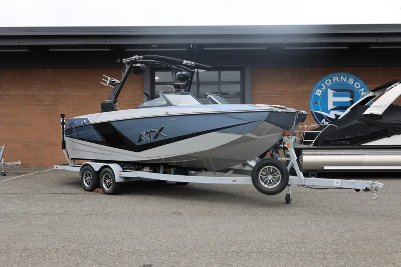 Slide: The Image of 2026 ATX Surf Boats 22 Type-S on trailer, parked outside Bjornson Marine. - 4