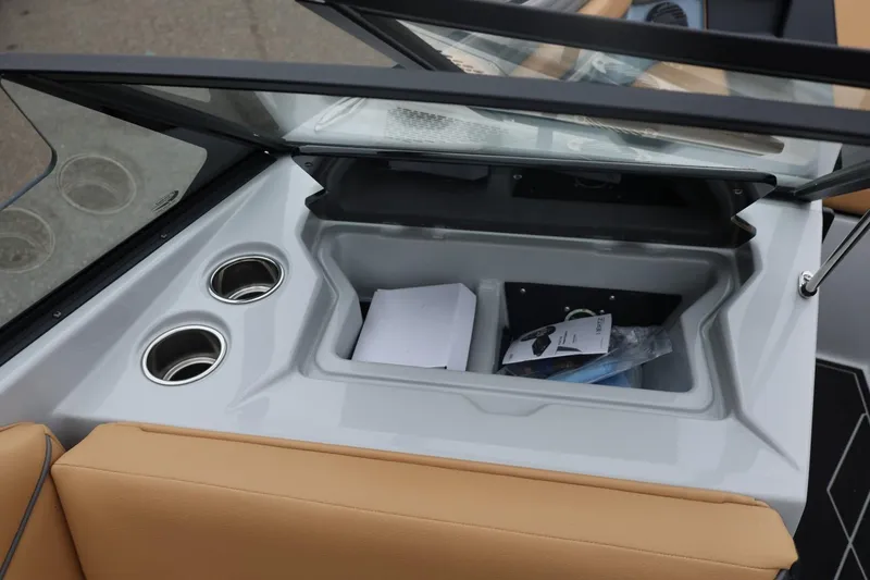 Slide: The Image of 2026 ATX Surf Boats 22 Type-S interior storage with cup holders and tan seating. - 42