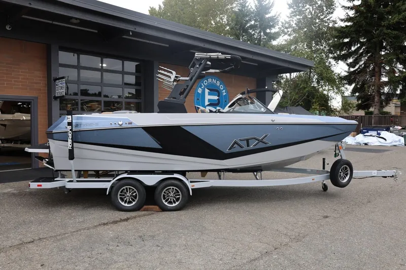 Slide: The Image of 2026 ATX Surf Boats 22 Type-S on trailer, parked outside a building. - 5