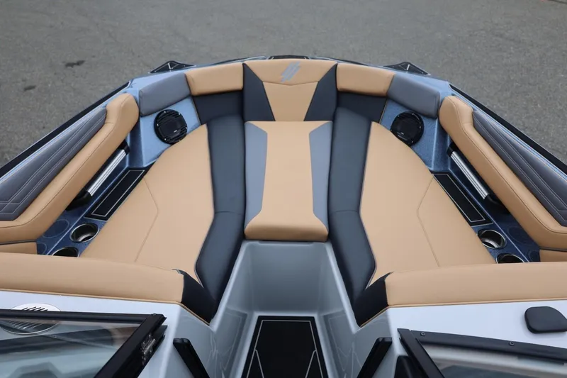 Slide: The Image of 2026 ATX Surf Boats 22 Type-S interior with tan and gray seating, cup holders, and speakers. - 54