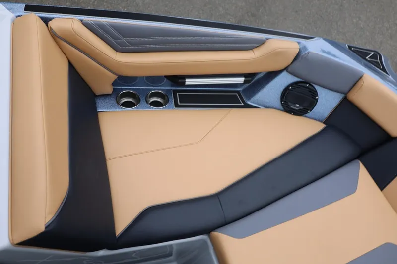 Slide: The Image of 2026 ATX Surf Boats 22 Type-S interior with tan and black seating, cup holders, and speaker. - 56