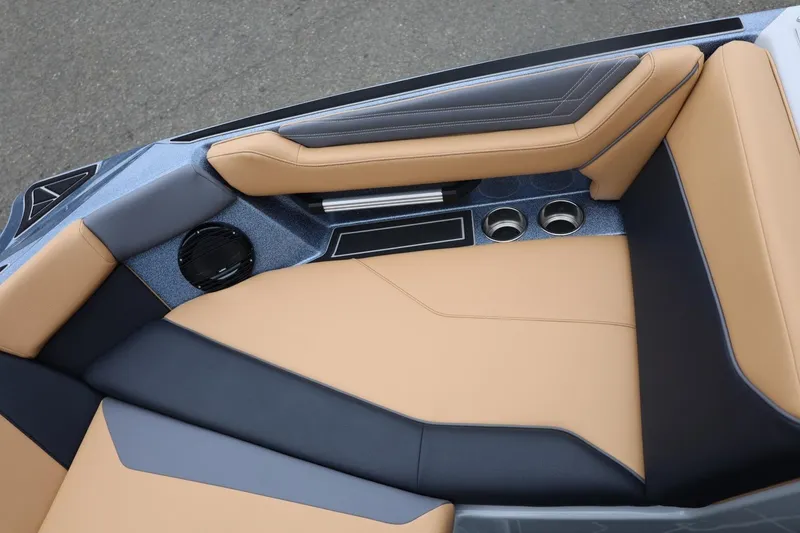 Slide: The Image of 2026 ATX Surf Boats 22 Type-S interior with tan and black seating, cup holders, and speaker. - 57