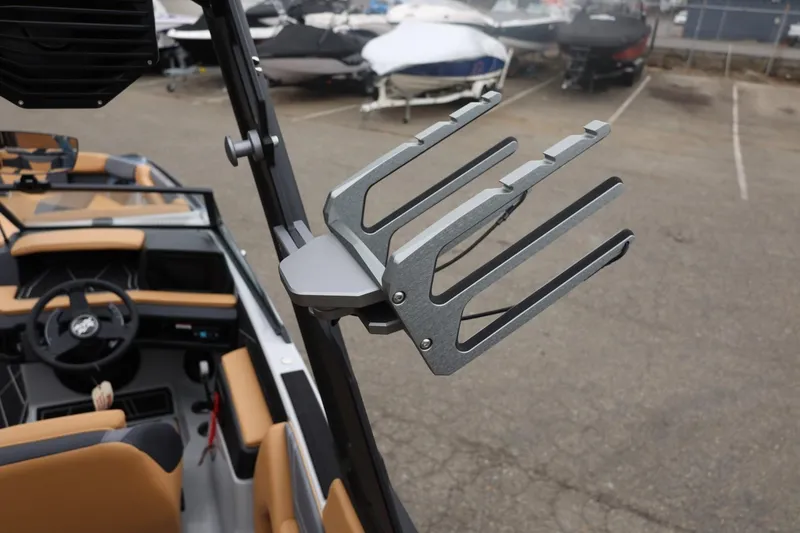 Slide: The Image of 2026 ATX Surf Boats 22 Type-S interior with wakeboard rack, parked in a marina. - 66