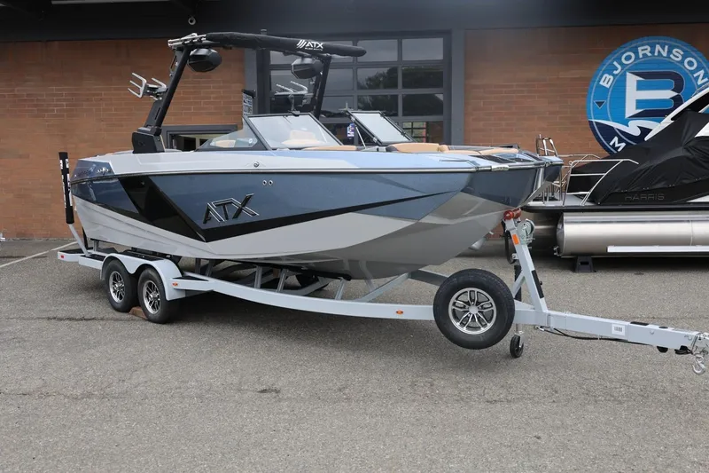Slide: The Image of 2026 ATX Surf Boats 22 Type-S on trailer, parked outside a building. - 7