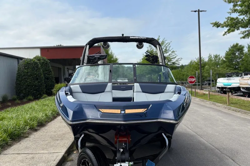 Slide: The Image of 2025 MasterCraft NXT20 boat parked outdoors, showcasing sleek design and modern features. - 4