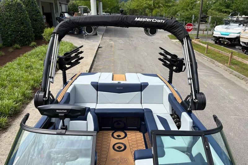 Slide: The Image of 2025 MasterCraft NXT20 boat interior with seating and wakeboard racks. - 5