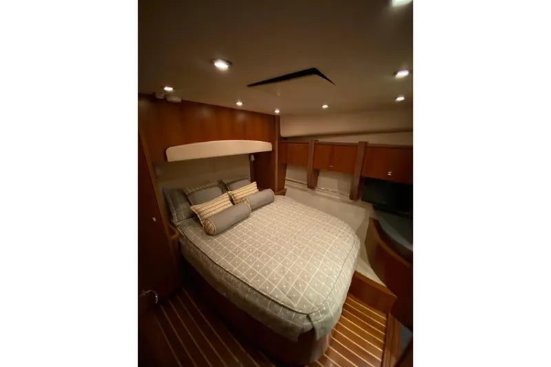 Slide: The Image of Luxurious bedroom interior of 2012 Tiara Yachts 4800 Convertible with elegant bedding and wood finish. - 13