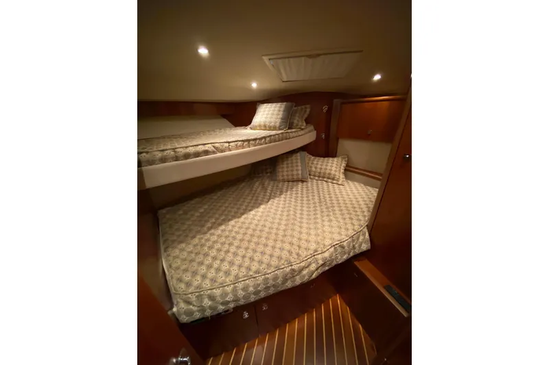 Slide: The Image of Interior cabin of 2012 Tiara Yachts 4800 Convertible with cozy bunk beds. - 14