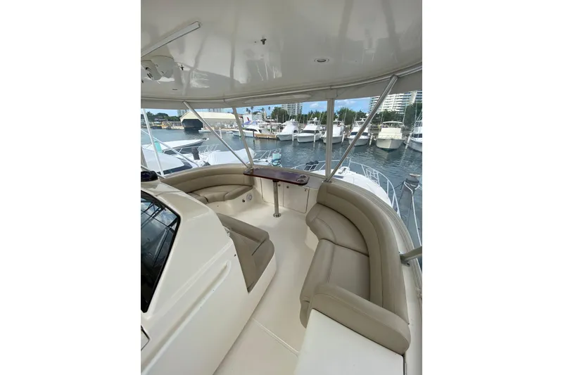 Slide: The Image of Luxurious 2012 Tiara Yachts 4800 Convertible with spacious seating, docked at marina. - 6
