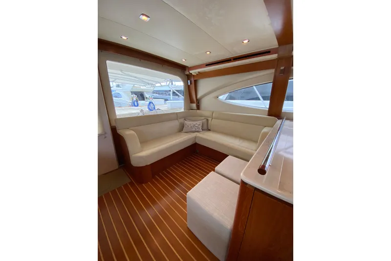 Slide: The Image of Luxurious interior of 2012 Tiara Yachts 4800 Convertible with elegant seating and wood flooring. - 8