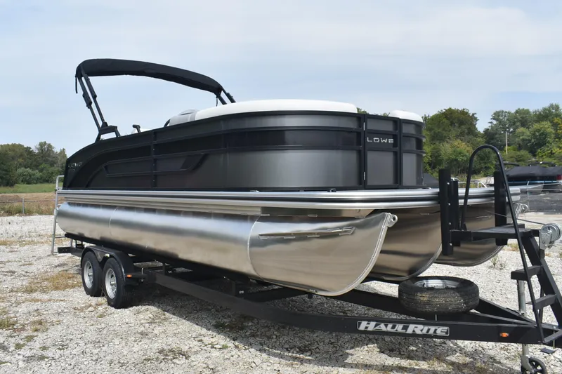 Slide: The Image of 2026 Lowe SS 230 DV pontoon boat on Haul-Rite trailer, parked outdoors. - 13