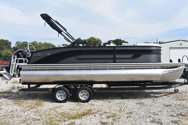 Slide: The Image of 2026 Lowe SS 230 DV pontoon boat on trailer, parked outdoors. - 14
