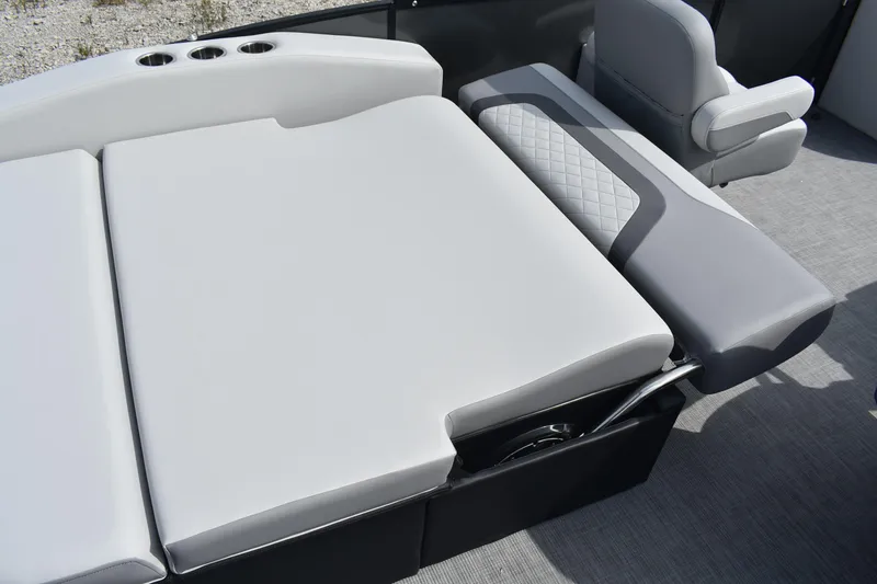 Slide: The Image of 2026 Lowe SS 230 DV boat interior with gray cushioned seating and cup holders. - 16