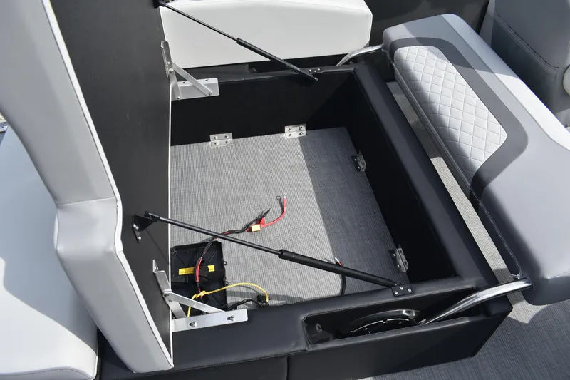 Slide: The Image of Open storage compartment in 2026 Lowe SS 230 DV boat with seating and wiring visible. - 17