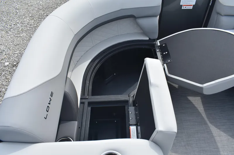 Slide: The Image of 2026 Lowe SS 230 DV boat interior with open storage compartment and cushioned seating. - 22