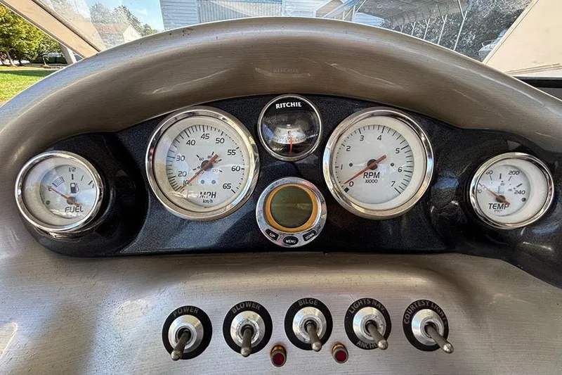 Slide: The Image of Dashboard of a 2009 Tahoe Q5i Sport boat with gauges and switches. - 4