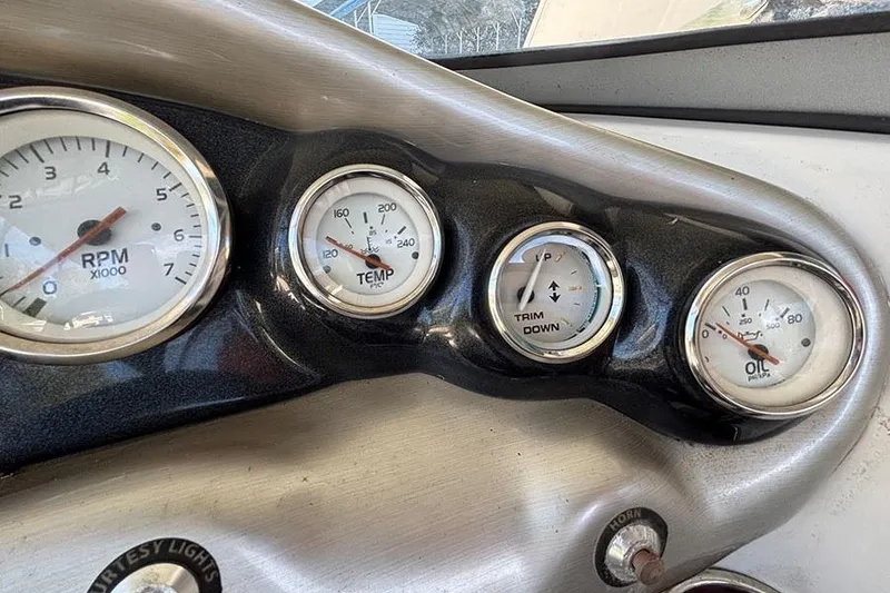 Slide: The Image of Dashboard gauges of a 2009 Tahoe Q5i Sport boat, showing RPM, temperature, trim, and oil pressure. - 5