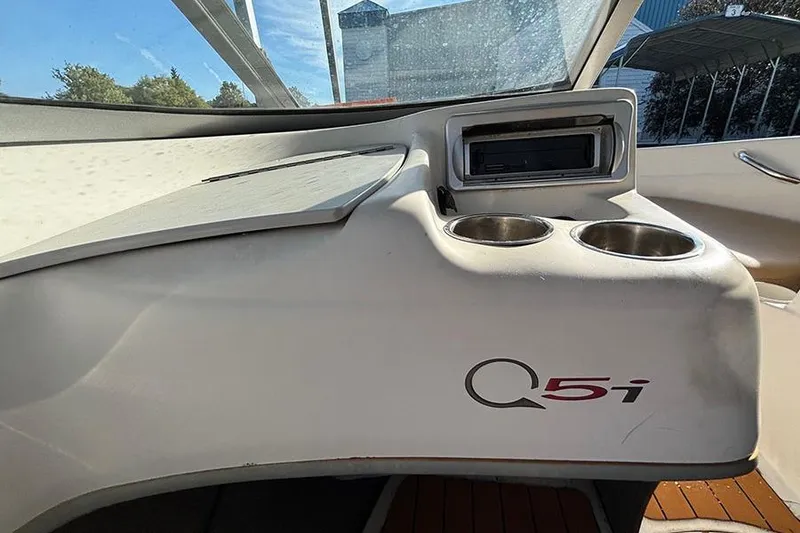 Slide: The Image of Interior of a 2009 Tahoe Q5i Sport boat with cup holders and dashboard. - 6