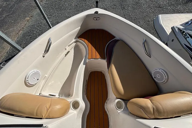 Slide: The Image of 2009 Tahoe Q5i Sport boat interior with tan seats and wood flooring. - 9