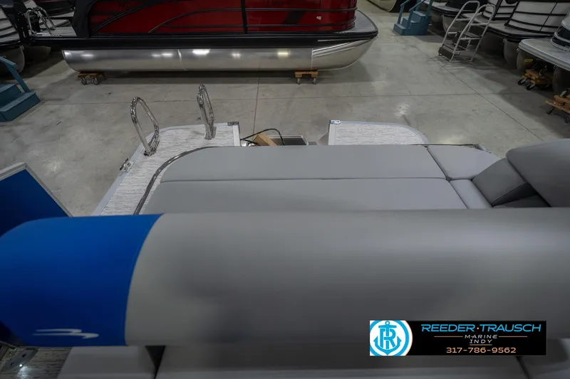 Slide: The Image of 2026 Bennington 23 SSB pontoon boat interior with gray seating and blue accents. - 18