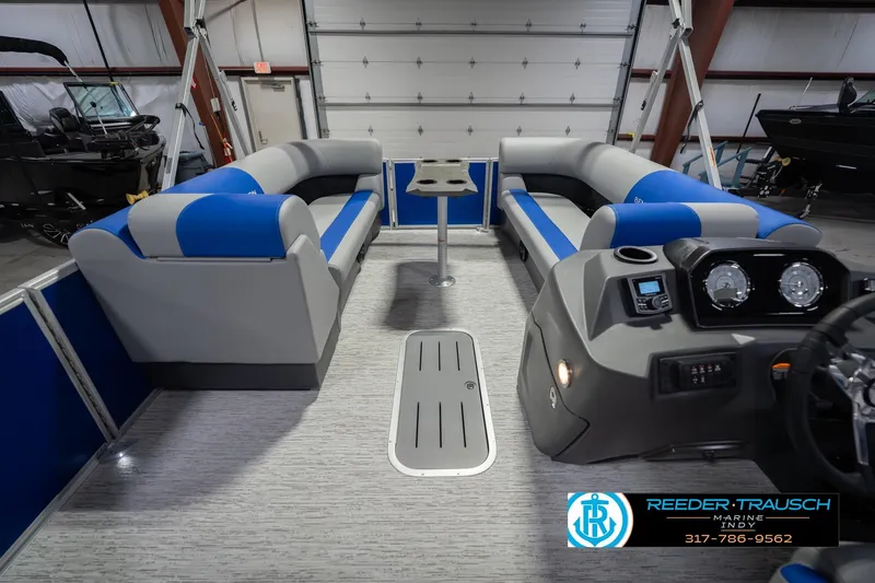 Slide: The Image of 2026 Bennington 23 SSB pontoon boat interior with blue and gray seating, modern dashboard. - 20