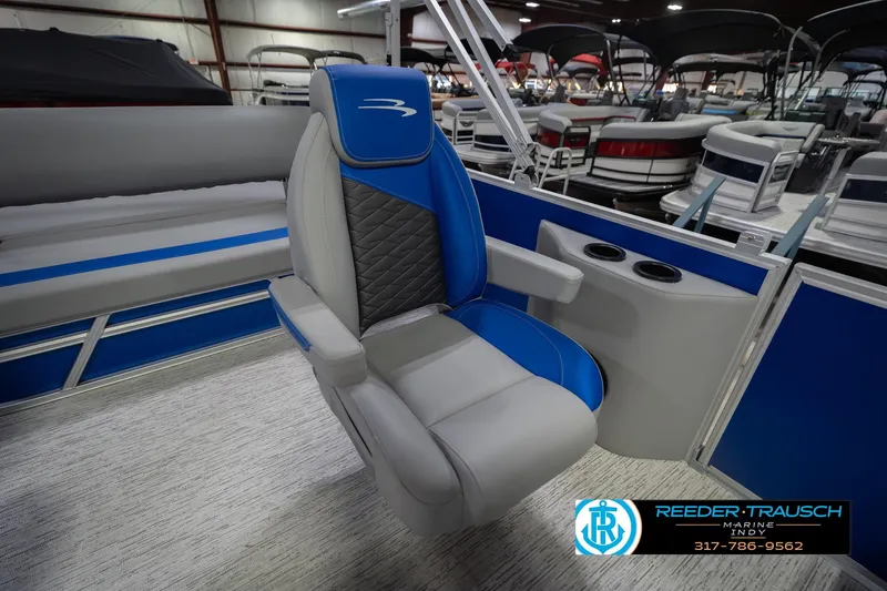 Slide: The Image of 2026 Bennington 23 SSB boat interior with blue and gray seating, cup holders visible. - 27