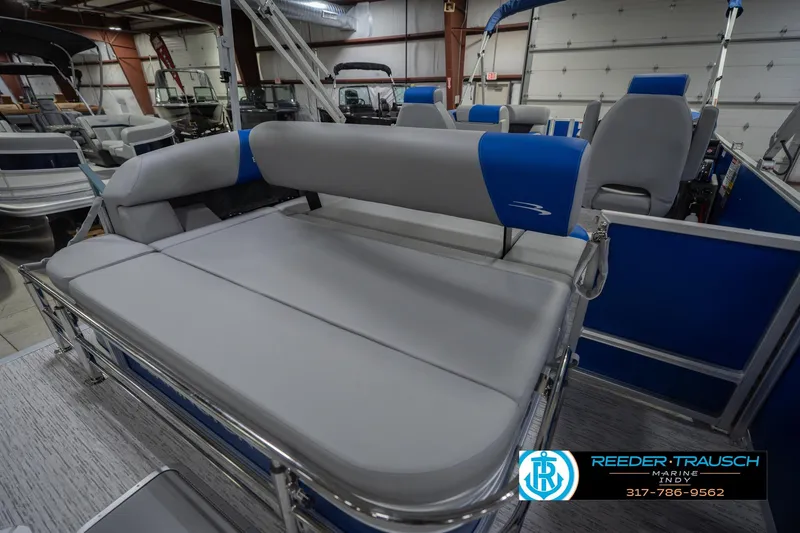 Slide: The Image of 2026 Bennington 23 SSB pontoon boat interior with gray and blue seating in showroom. - 28