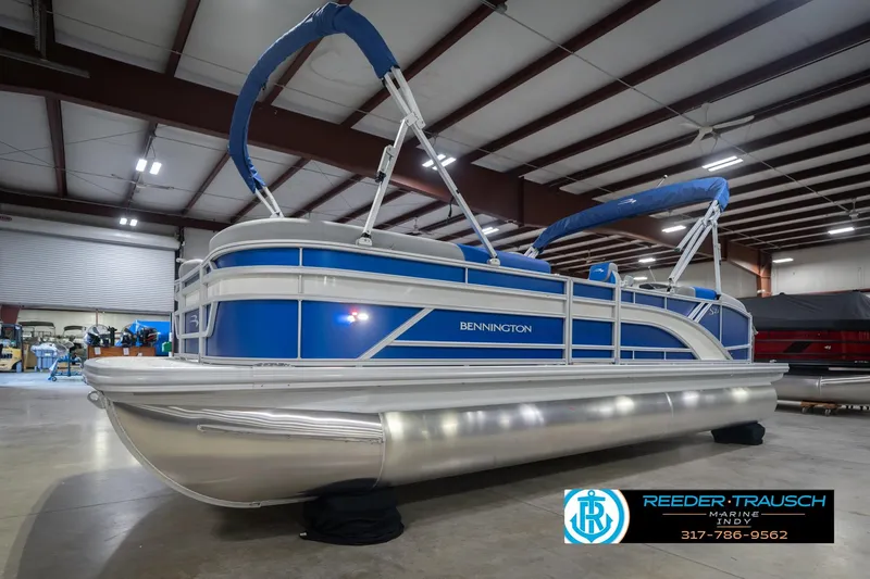 Slide: The Image of 2026 Bennington 23 SSB pontoon boat in showroom, blue and silver design. - 3