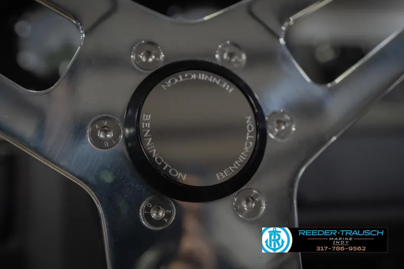 Slide: The Image of Close-up of 2026 Bennington 23 SSB steering wheel with logo and Reeder-Trausch Marine branding. - 32