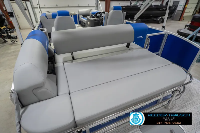 Slide: The Image of 2026 Bennington 23 SSB pontoon boat interior with gray and blue seating in showroom. - 43