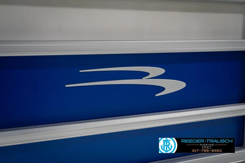 Slide: The Image of 2026 Bennington 23 SSB boat logo on blue panel, Reeder-Trausch Marine branding. - 48