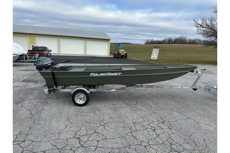 Slide: The Image of 2024 Polar Kraft MV 1648 Jon Boat with Yamaha 20 hp engine on trailer, outdoor setting. - 2