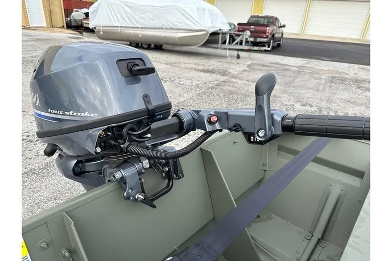 Slide: The Image of 2024 Polar Kraft MV 1648 Jon Boat with Yamaha 20 hp engine, trailer visible in background. - 6