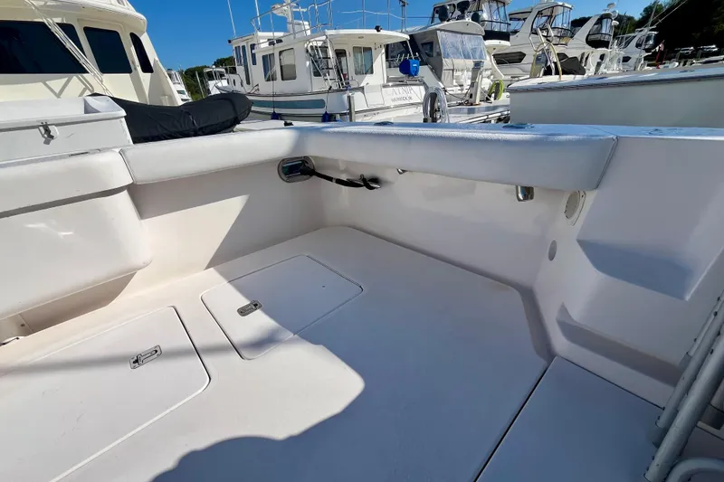 Slide: The Image of 2006 Bertram 390 Convertible boat deck with seating and dock view. - 11