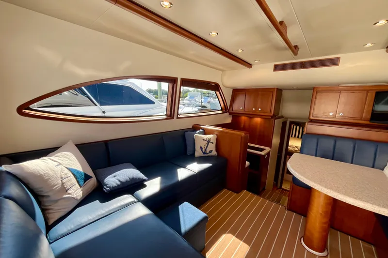 Slide: The Image of Luxurious interior of 2006 Bertram 390 Convertible yacht with elegant seating and wood finishes. - 13