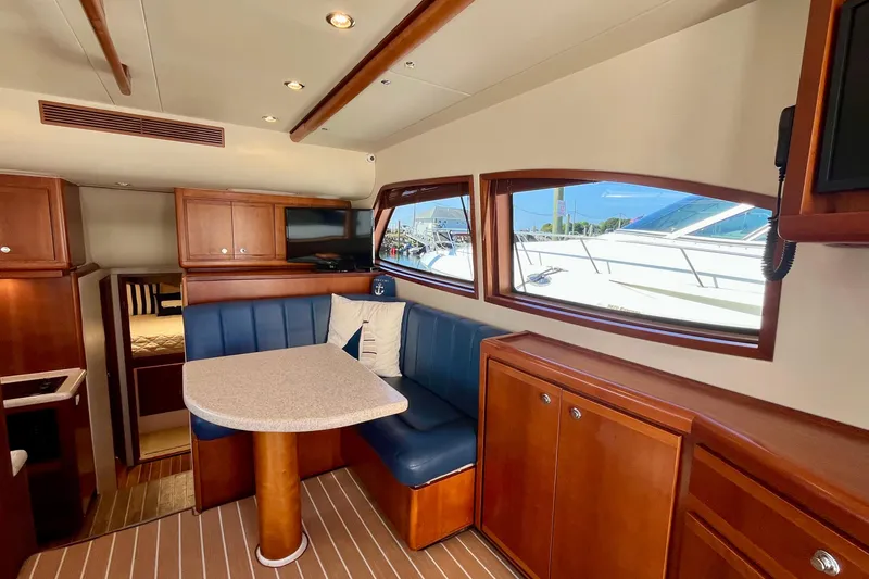 Slide: The Image of Luxurious interior of 2006 Bertram 390 Convertible yacht with plush seating and wooden accents. - 14
