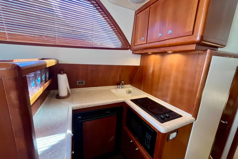 Slide: The Image of Interior of 2006 Bertram 390 Convertible yacht with kitchen and window view. - 17
