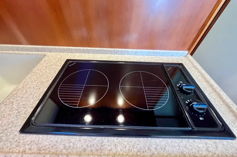 Slide: The Image of Wood-paneled refrigerator in 2006 Bertram 390 Convertible yacht interior. - 19