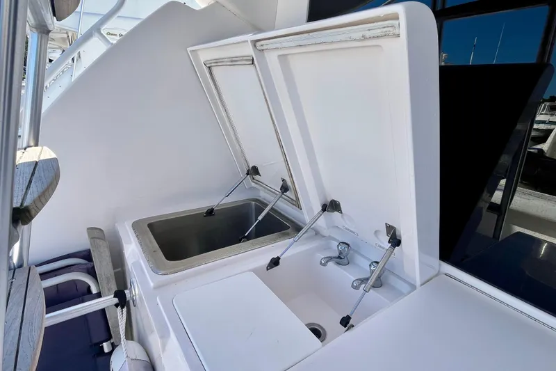 Slide: The Image of Kitchen area of 2006 Bertram 390 Convertible with open drawer and countertop. - 21