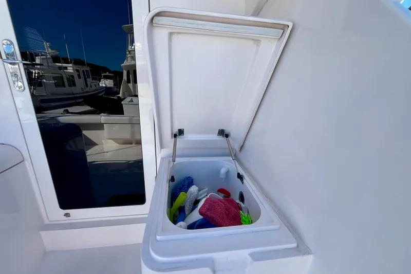 Slide: The Image of 2006 Bertram 390 Convertible yacht with gold logo on white exterior. - 25