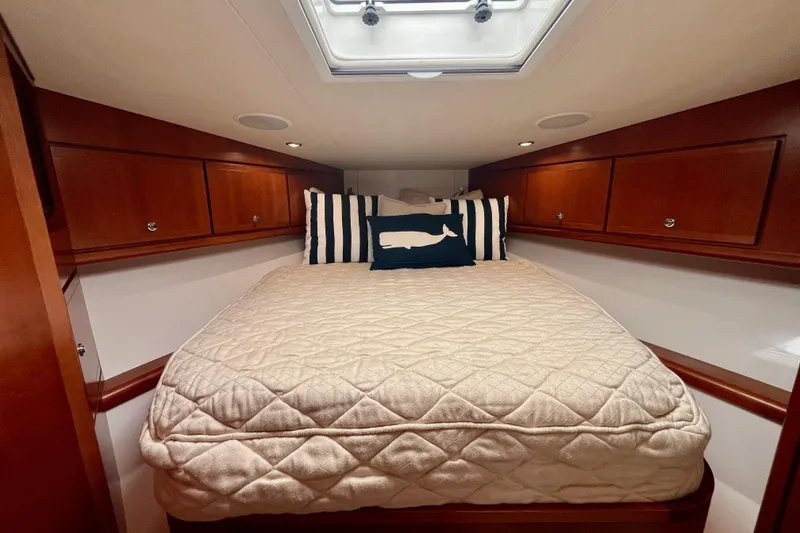 Slide: The Image of Interior of 2006 Bertram 390 Convertible yacht with cozy bedroom and nautical decor. - 33