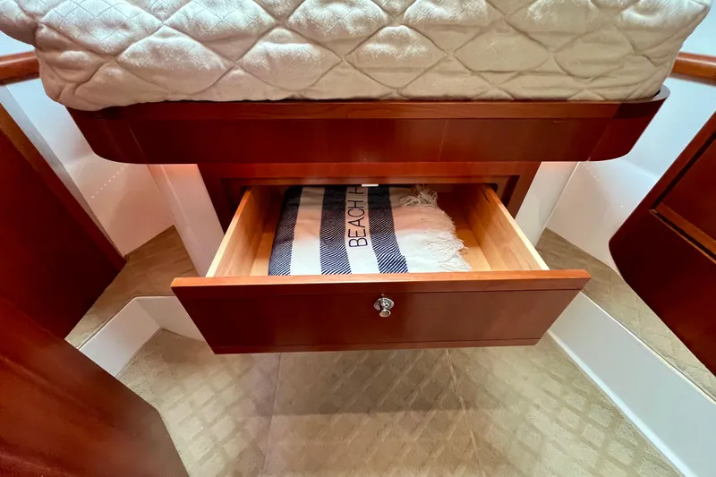 Slide: The Image of Luxurious cabin interior of 2006 Bertram 390 Convertible yacht with cozy bedding. - 34