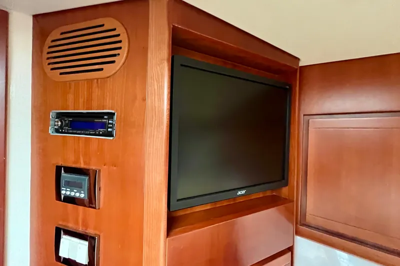 Slide: The Image of Wooden closet with jackets inside a 2006 Bertram 390 Convertible yacht bedroom. - 36