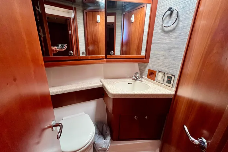 Slide: The Image of Twin beds in the 2006 Bertram 390 Convertible cabin, featuring cozy bedding and pillows. - 39