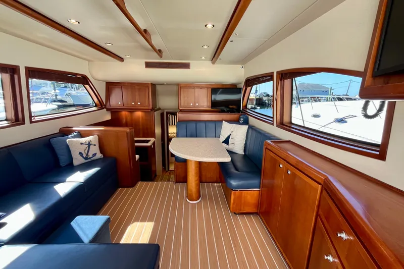 Slide: The Image of 2006 Bertram 390 Convertible yacht docked, featuring a sleek design and spacious deck area. - 4