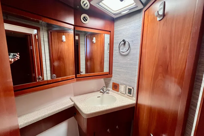 Slide: The Image of Bathroom interior of 2006 Bertram 390 Convertible yacht with wooden cabinetry and modern fixtures. - 40