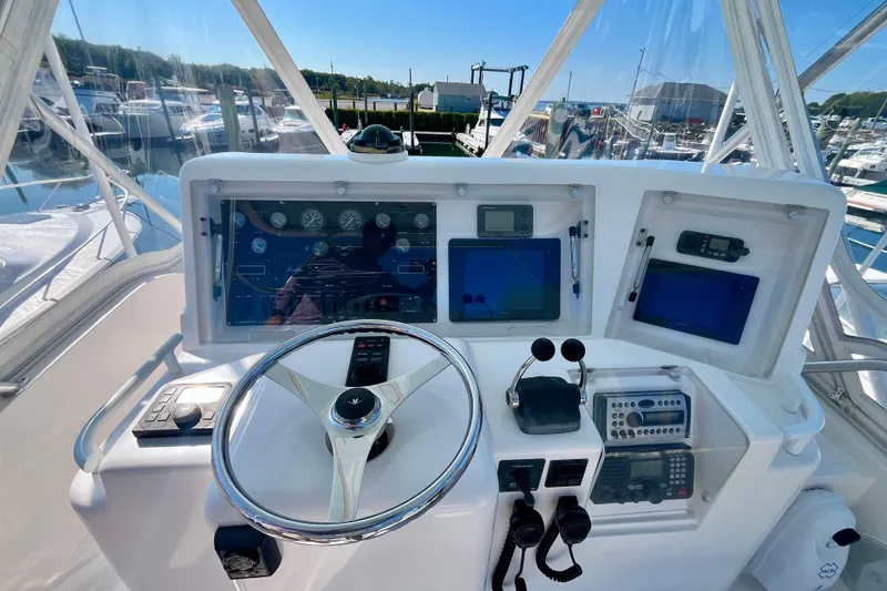 Slide: The Image of 2006 Bertram 390 Convertible yacht helm with modern navigation controls and steering wheel. - 43