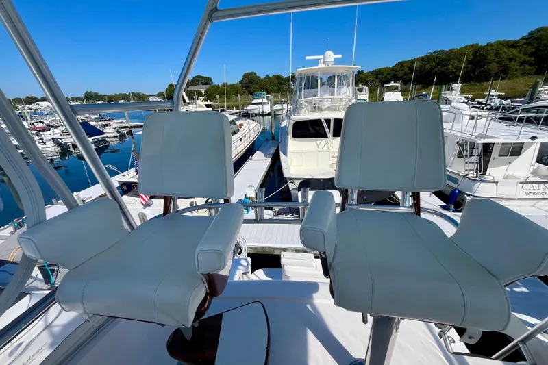 Slide: The Image of 2006 Bertram 390 Convertible yacht with rod holders, docked in a marina. - 45